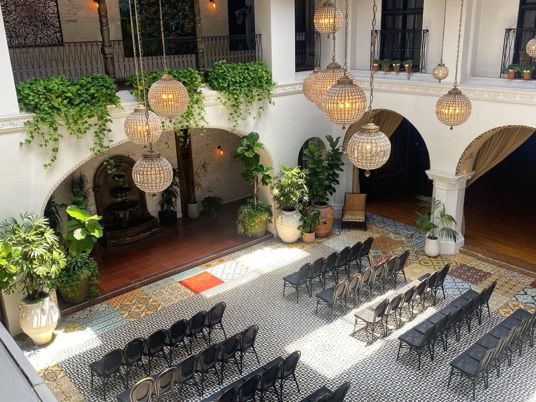 Plants decorating a historic courtyard set for an event