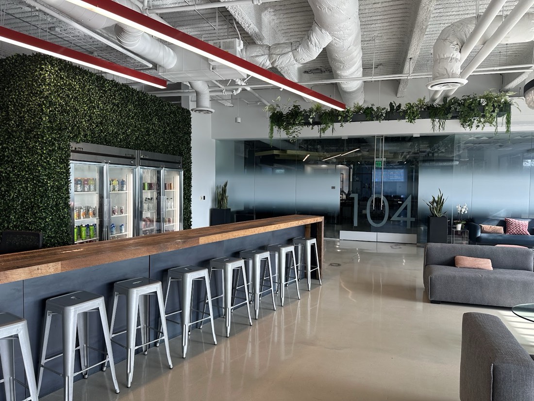 Lush hedge wall installed behind an office bar