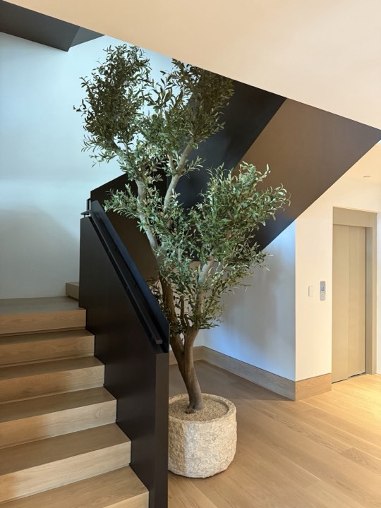 Custom faux olive tree in a stairwell
