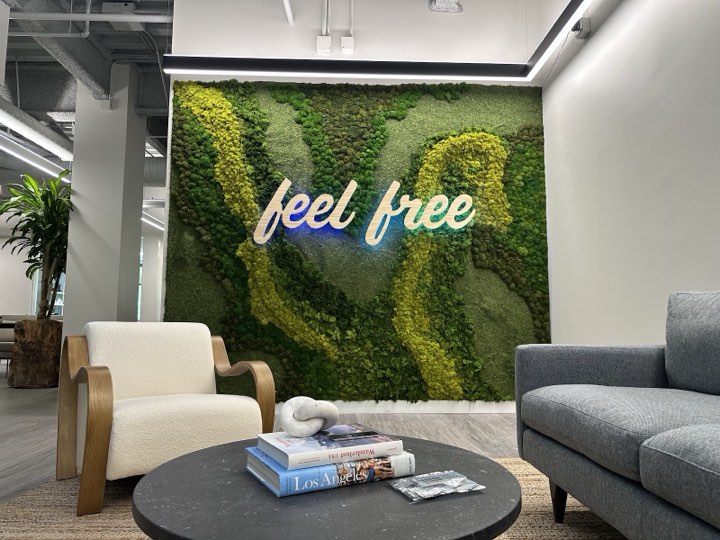 Preserved moss wall with a custom 'feel free' logo inlay in an office lounge